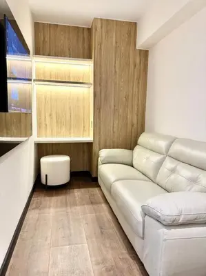 a living room with a white couch and a table at Deluxe Apartment in San Isidro in Lima