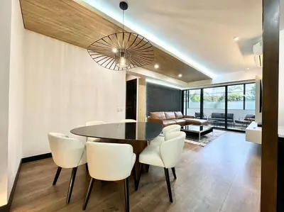 a dining room with a table and white chairs at Deluxe Apartment in San Isidro in Lima