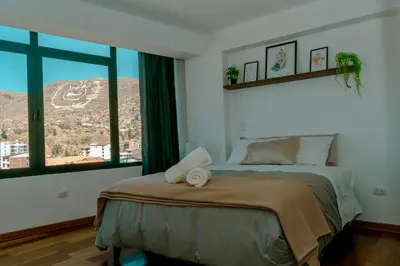 a bedroom with a bed with a view of a mountain at Willka Wasi Cusco in Cusco