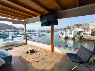 a living room with a view of a marina at Lindo chalet en PUCUSANA in Pucusana