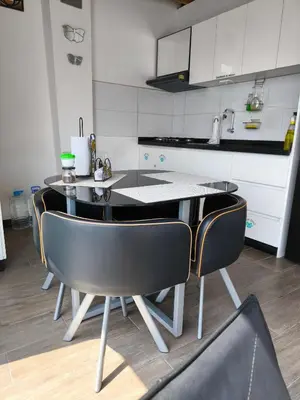 a kitchen with a table and chairs in a room at Lindo chalet en PUCUSANA in Pucusana