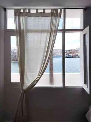 a window with a view of the water at Ninfas 371 in Pucusana