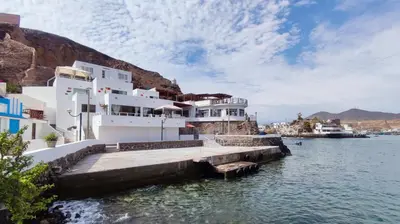 a large white building on the water with a dock at Ninfas 371 in Pucusana