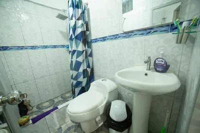 a small bathroom with a sink and a toilet at Apartamento La Merced in La Merced