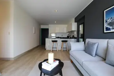 a living room with a couch and a table at Stelar by Wynwood House in Lima