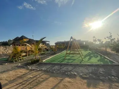 a park with a playground with a swing at Bungalows frente al mar en playa Wakama in San Vicente de Cañete