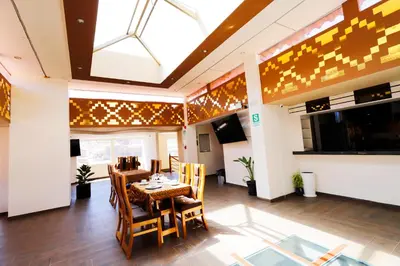 a dining room with a table and chairs at INKALAM cusco in Cusco