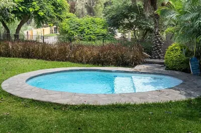 a small swimming pool in the middle of a yard at Casa Cusco in Cieneguilla