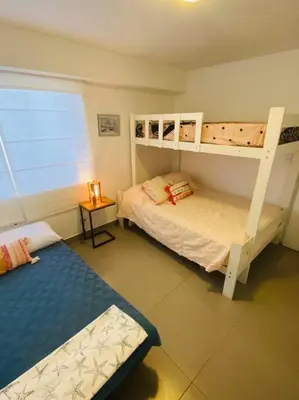 a bedroom with two bunk beds and a bed at Alojamiento frente al mar en San Bartolo in San Bartolo