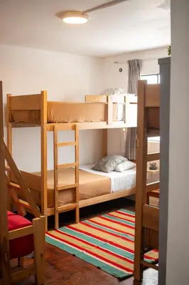 a room with two bunk beds and a rug at Temazcal Hostel in Lima