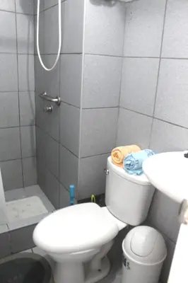 a bathroom with a toilet and a sink and a shower at Palmeras Apartments San Isidro in Lima