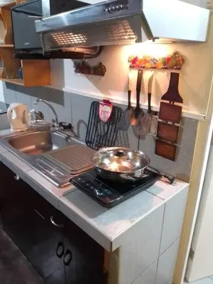 a kitchen counter with a frying pan on a stove at Palmeras Apartments San Isidro in Lima