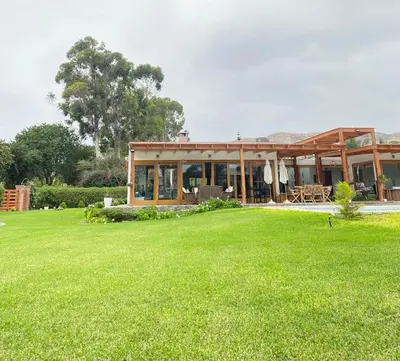 a house with a large lawn in front of it at Casa de campo en Hacienda San Andres in San Andrés