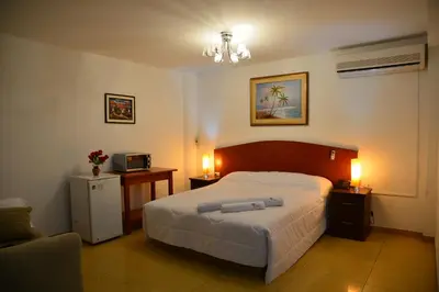 a bedroom with a bed and two lamps and a couch at Qallwa Asia in Asia