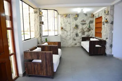 a bedroom with two beds and a stone wall at Qallwa Asia in Asia