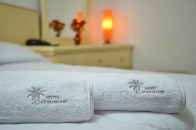 a pair of towels sitting on top of a bed at Qallwa Asia in Asia