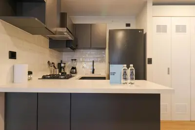a kitchen with a refrigerator and a counter top at Moreyra by Wynwood House in Lima