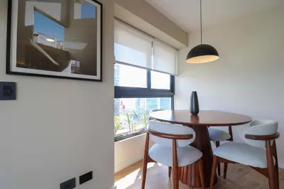 a dining room with a table and chairs and a window at Moreyra by Wynwood House in Lima