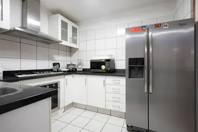 a kitchen with a stainless steel refrigerator and a microwave at Nogales Family Apartments by Vibrant in Lima