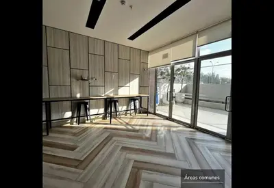a dining room with a table and a large window at Apartamento Céntrico cerca a San Isidro in Lima