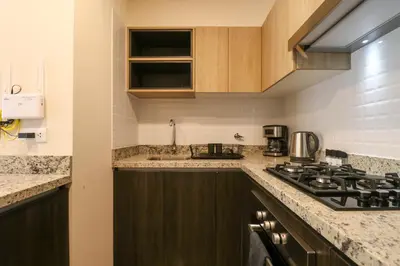 a kitchen with a stove and a sink at Benavides by Wynwood House in Lima