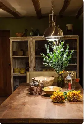 a kitchen with a wooden table with a plant on it at SAMAY WASI Rest house in Ollantaytambo