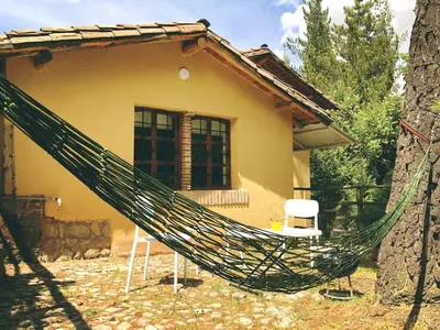a hammock in front of a house at The Tree House in Cusco