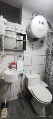 a small bathroom with a toilet and a sink at Posada Estela in Lima