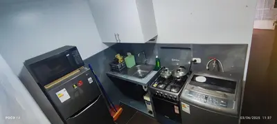 a small kitchen with a stove and a sink at Posada Estela in Lima