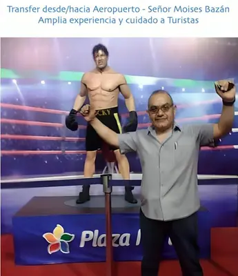 a man standing in front of a wrestler in a wrestling ring at Posada Estela in Lima