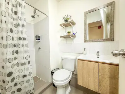 a bathroom with a toilet and a sink and a mirror at Exclusivo con vista al mar - Blue One in Lima