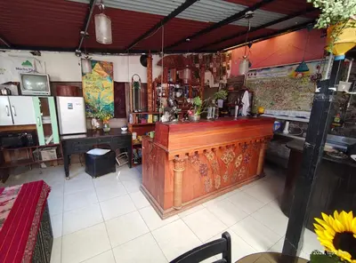 a restaurant with a large wooden bar in a room at IG Art in Cusco