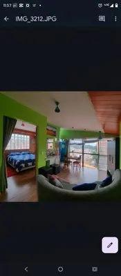 a living room with a couch and a bedroom at IG Art in Cusco