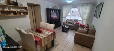 a living room with a table and chairs and a tv at Departamento Centenario in Lima