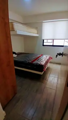 a bedroom with a bed in a room with a window at Depa en Punta Hermosa in Punta Hermosa