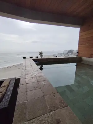 a swimming pool with a view of the ocean at Depa en Punta Hermosa in Punta Hermosa