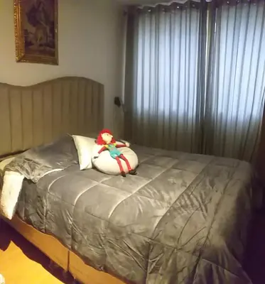 a bed with a stuffed animal on top of it at La Casa de mi Abuelo in Cusco