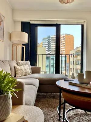 a living room with a couch and a large window at Lima Limón in Lima