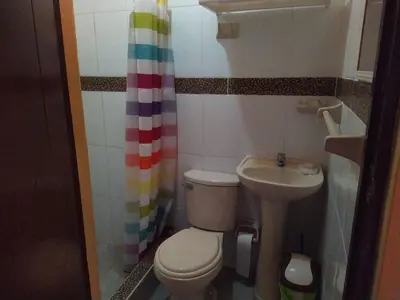 a small bathroom with a toilet and a sink at A great experience in the South cone of Lima! in Lima