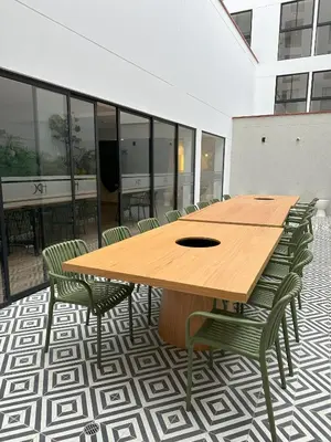 a wooden table and chairs in a room with windows at Modern 2Br Apt Fully Furnished Barranco in Lima