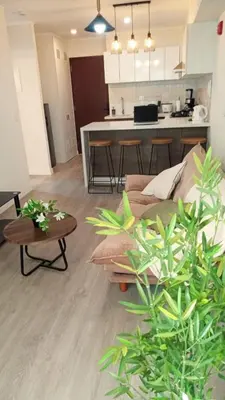 a living room with a couch and a kitchen at Departamento amoblado de 1 dormitorio in Lima