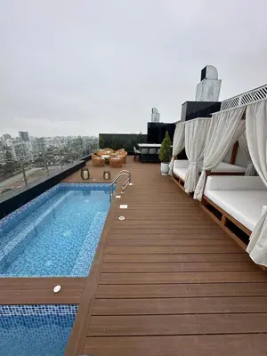 a balcony with a swimming pool on top of a building at Departamento amoblado de 1 dormitorio in Lima