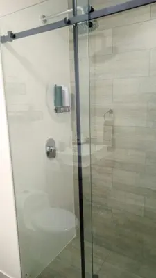 a glass shower door with a toilet in a bathroom at Departamento amoblado de 1 dormitorio in Lima
