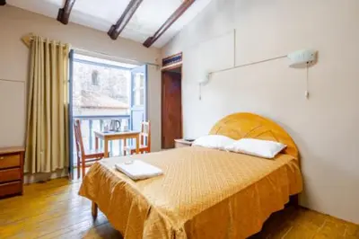 a bedroom with a bed with a laptop on it at Vista al Qoricancha - 2 cuadras de la Plaza in Cusco