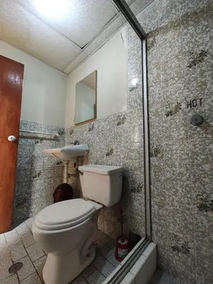 a bathroom with a toilet and a shower at Vista al Qoricancha - 2 cuadras de la Plaza in Cusco