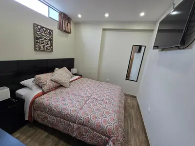 a small bedroom with a bed and a television at Miramar Vip in Barranca