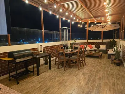 a living room with a table and a piano at Miramar Vip in Barranca