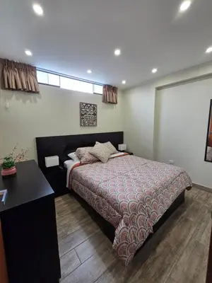 a bedroom with a bed and a desk in it at Miramar Vip in Barranca