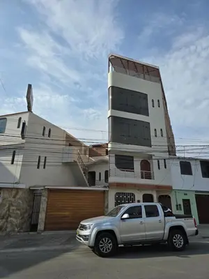 a silver truck parked in front of a building at Miramar Vip in Barranca