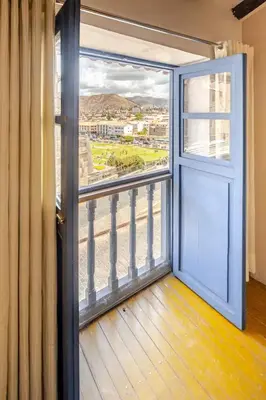 an open door to a balcony with a view at Vista Qoricancha - 2 cuadras Plaza Principal in Cusco